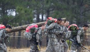Army Special Forces candidates carry a log during a recent Special Forces Assessment and Selection class at Camp Mackall at Fort Bragg, North Carolina. Two female officers have qualified to undergo training to become Green Berets. Photo courtesy of the U.S. Army